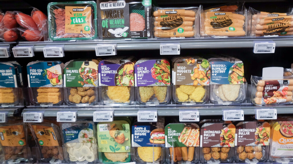 A selection of plant-based meats on the shelf in a supermarket