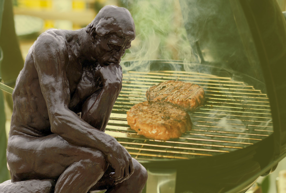 'The thinker' statue representing philosophy superimposed over an image of barbequing burgers